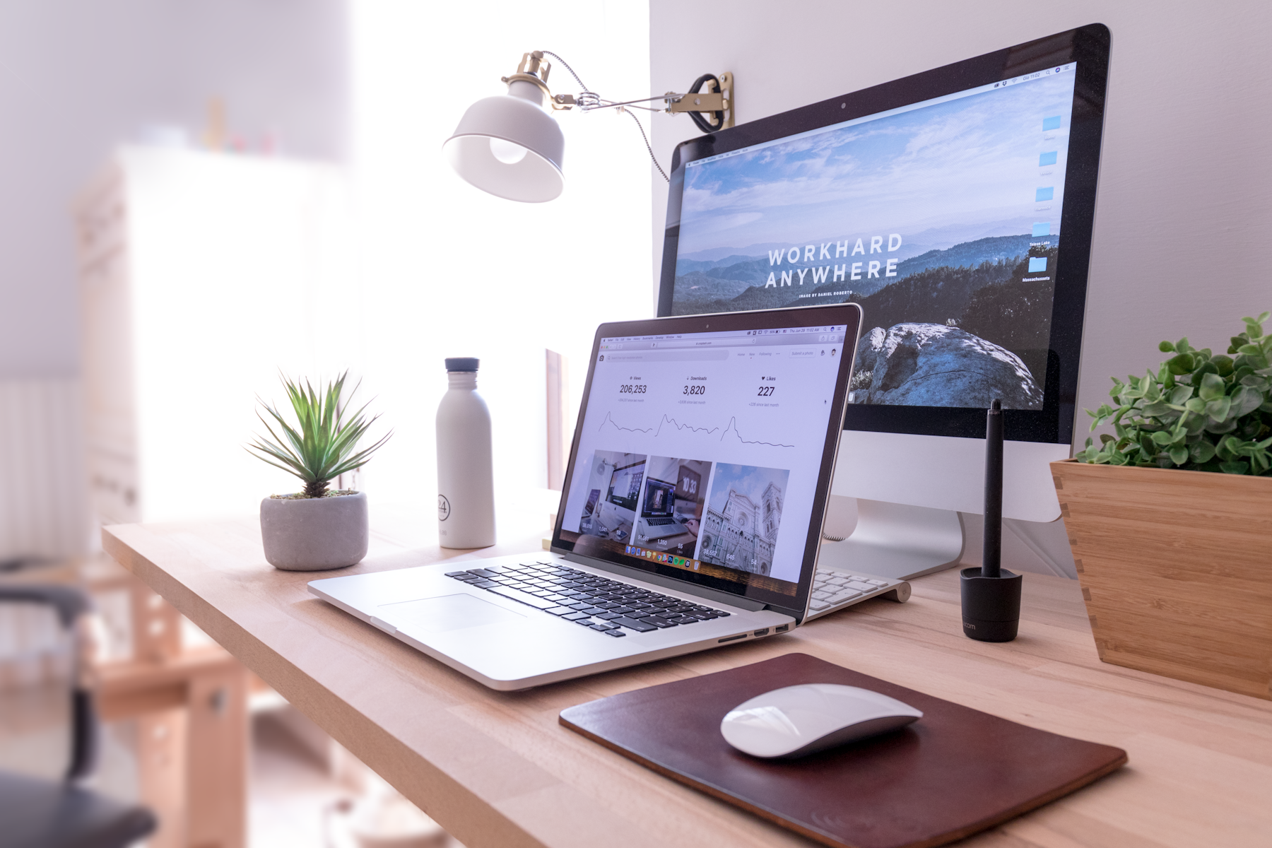 A tidy desk with a laptop and a desktop monitor