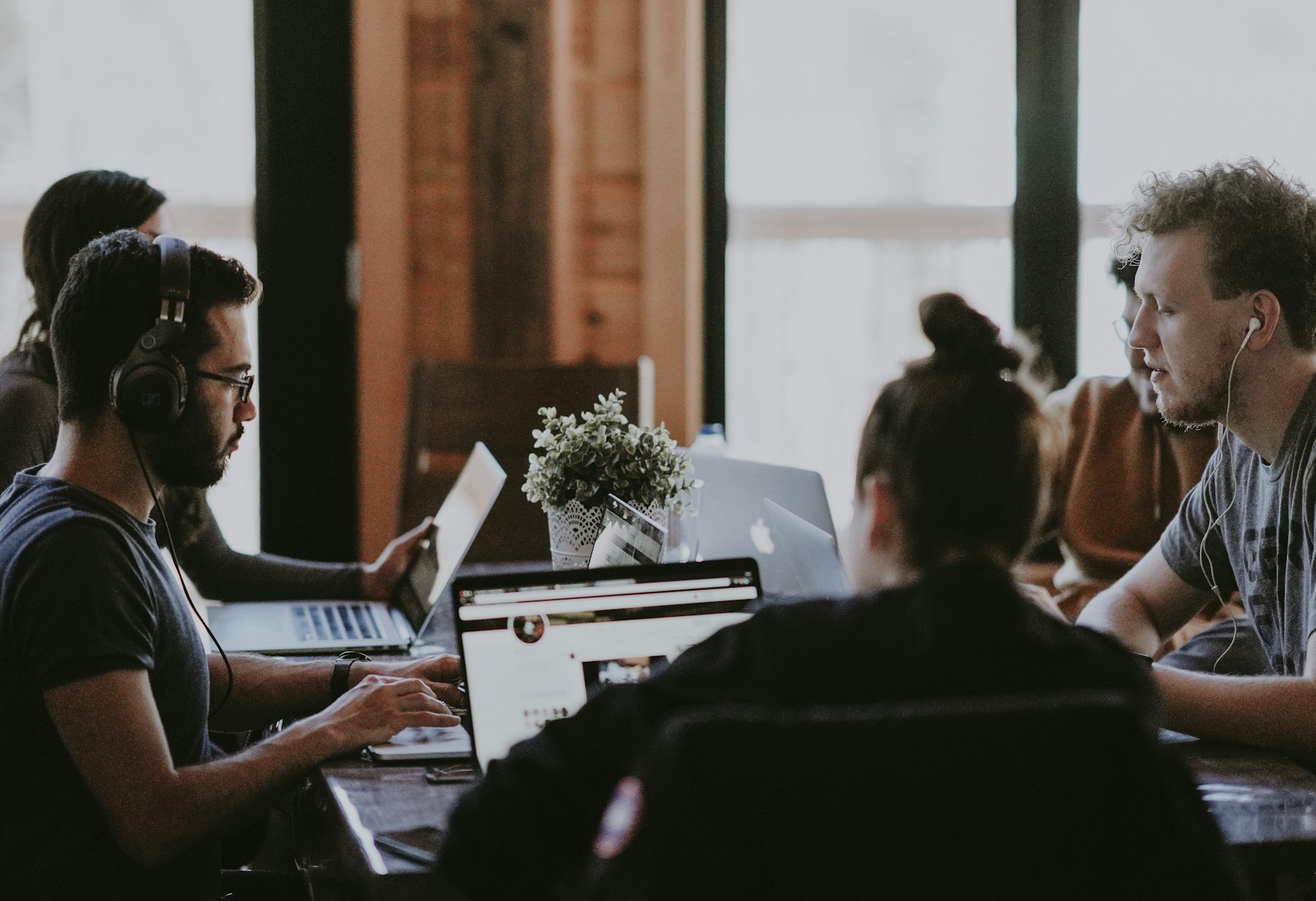 People working on laptops at a shared desk