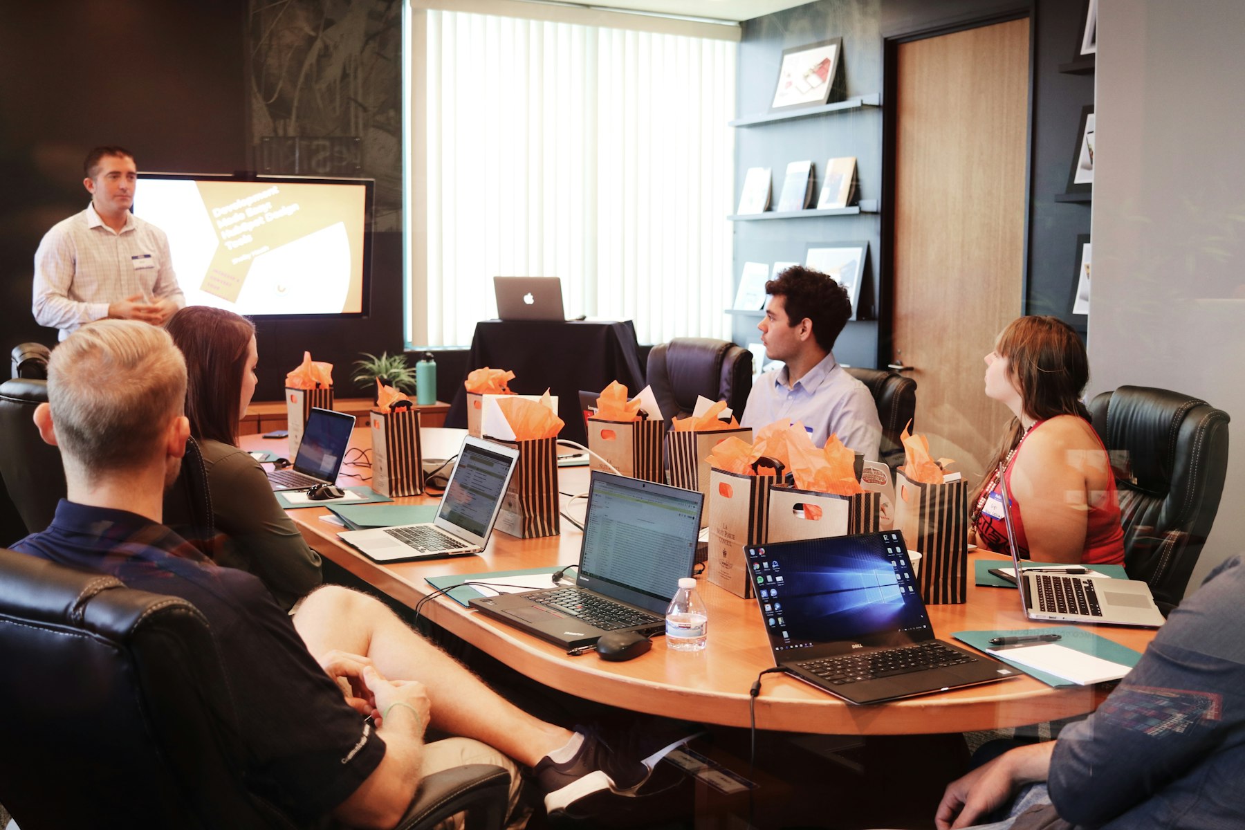 A team in discussion over a laptop and notebooks