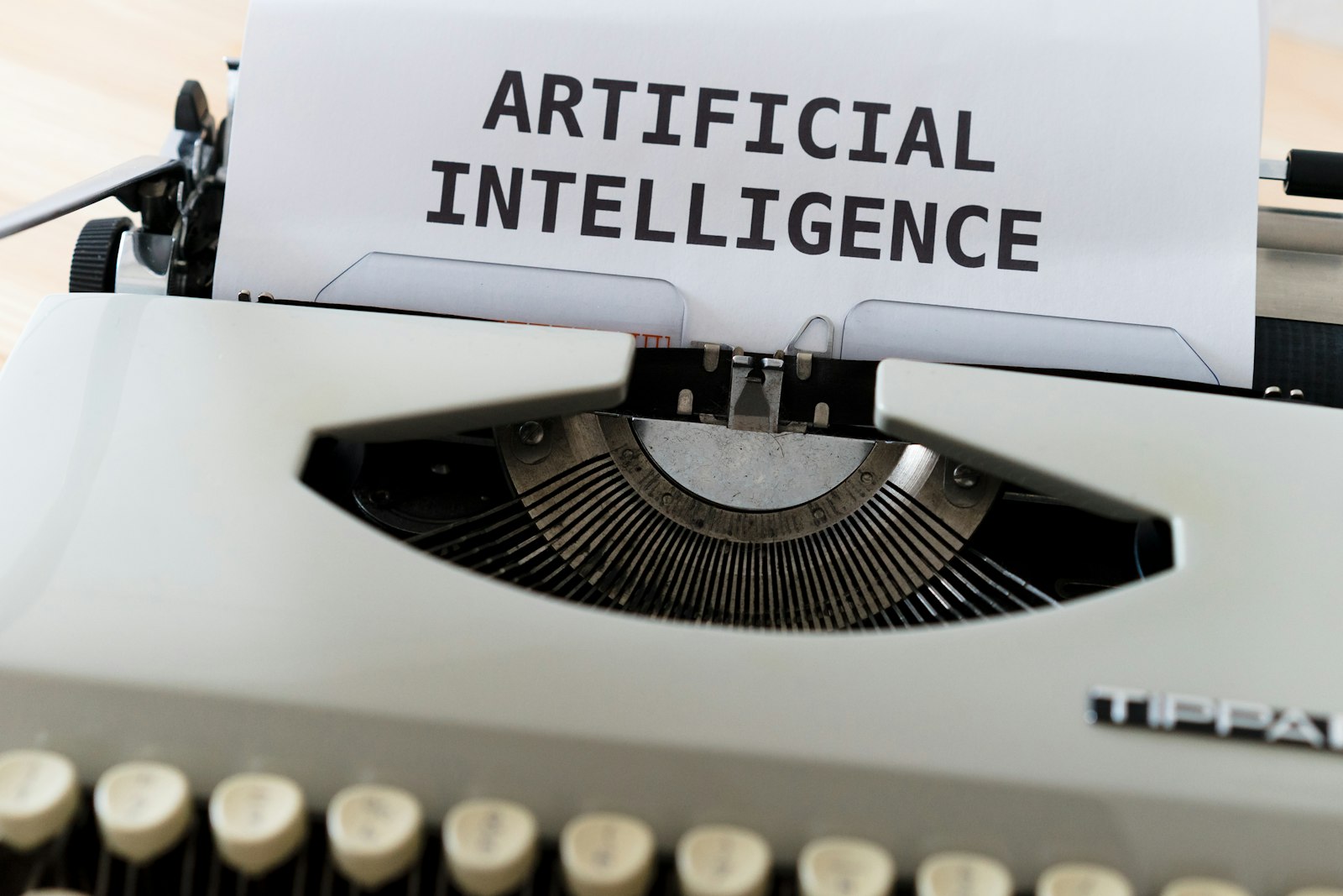 Human and robotic hands reaching toward an AI interface