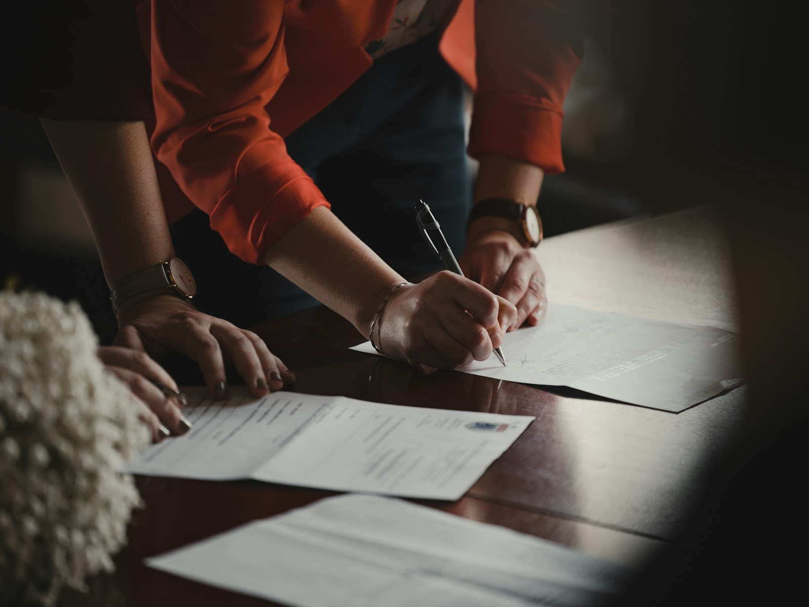 Signing a document at a desk