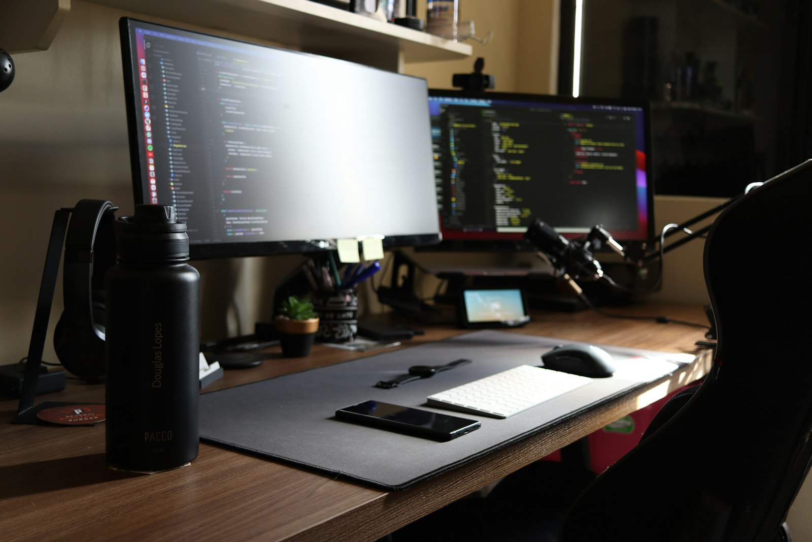 Two monitors on a desk workspace